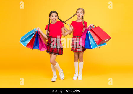 Pleasant shopping. purchase. black friday. holiday presents. Sale and discount. girls shopping. happy children with shopping bags. successful shopping. big sales. school girls with packages. Stock Photo