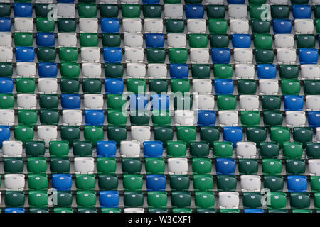 Rows of empty multi-coloured modern tip-up seats in a modern football stadium at the National Football Stadium at Windsor Park Belfast. Editorial use. Stock Photo