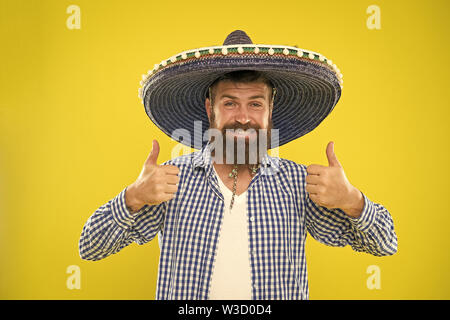 Mexican guy happy festive outfit ready to celebrate. Man bearded cheerful guy wear sombrero mexican hat yellow background. Mexican party concept. Celebrate traditional mexican holiday. Lets have fun. Stock Photo