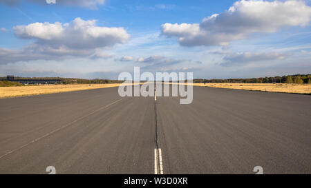 Runway on airport on clouded sunny day with blue sky Stock Photo