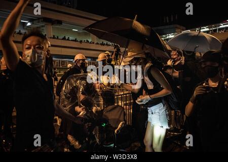 Hong Kong, China. 14th July, 2019. Protesters try to make some barricades at night after the march.Thousands of protesters marched in Sha Tin district as pro-democracy demonstrators continue with weekly rallies on the streets of Hong Kong for the past month, calling for the complete withdrawal of a controversial extradition bill. Credit: SOPA Images Limited/Alamy Live News Stock Photo