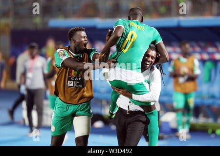 Cairo. 14th July, 2019. Senegal's Cheikhou Kouyate (top) celebrates team's score with teammates during the semifinal match between Senegal and Tunisia at the 2019 Africa Cup of Nations in Cairo, Egypt on July 14, 2019. Senegal won 1-0 and advanced to the final. Credit: Ahmed Gomaa/Xinhua/Alamy Live News Stock Photo