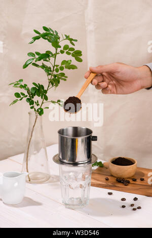 Premium Photo  'phin' traditional vietnamese coffee maker, place on the  top of glass, add ground coffee then pour hot water and wait until the  coffee dripping into the glass.