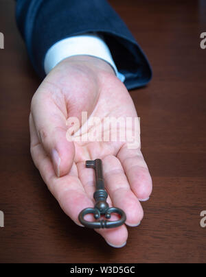 Businessman holding the old key. Business concepts. Stock Photo
