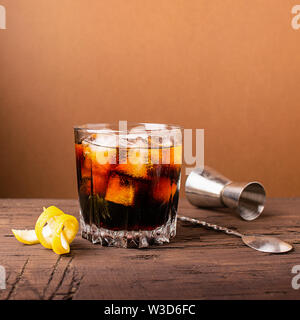 Strong alcoholic drink of brandy whiskey in a glass with ice cubes dark wooden background. Selective focus. Copy space. Stock Photo