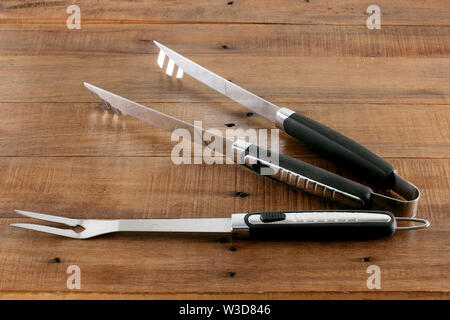 Barbeque Utensils on Rustic Wooden Background Stock Photo