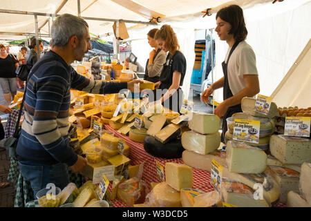 Amsterdam, Holland - June 22, 2019: Variety of cheese on the market at the Noordermarkt Stock Photo