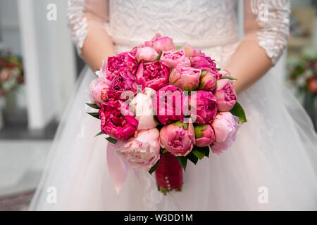 Beautiful wedding bouquet of flowers in bride’s hands Stock Photo