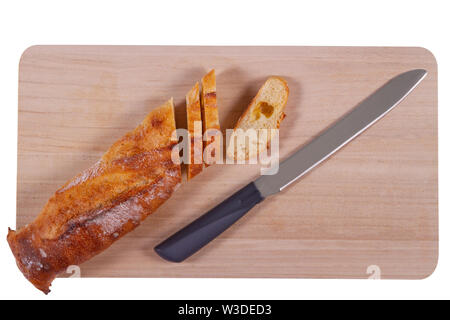 Wooden cutting board with sliced baguette and knife isolated on white background Stock Photo