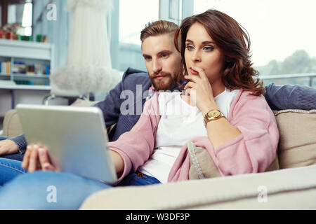 Young couple watching movie on digital tablet Stock Photo
