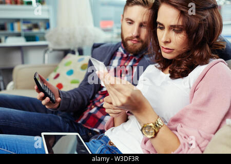 Couple paying bills with digital tablet Stock Photo