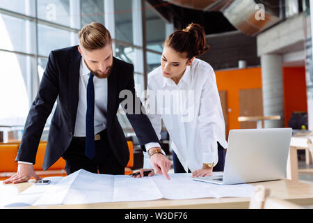 Coworkers working in office. Business people planning over desk Stock Photo