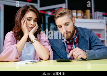 Sad couple counting home finances Stock Photo