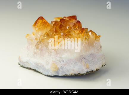 Citrine gemstone. Cluster of several yellow quartz crystals on white background Stock Photo