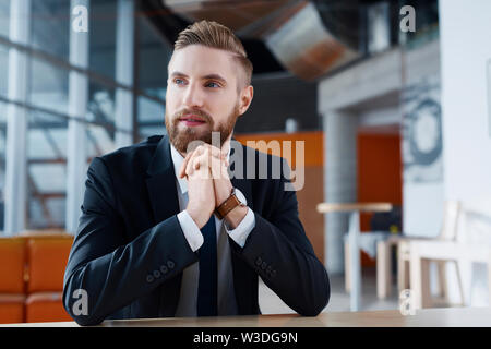 Confident young businessman looking away Stock Photo