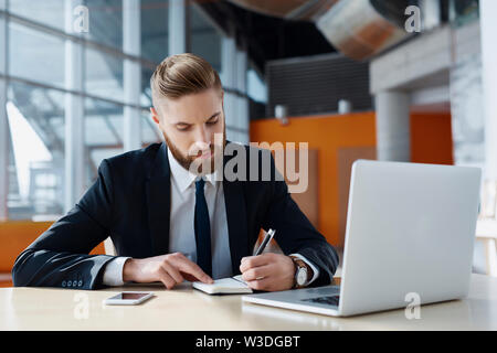 Stylish businessman working with laptop at office Stock Photo