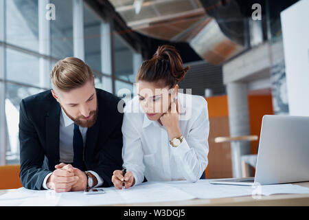 Couple of architects working on construction project Stock Photo