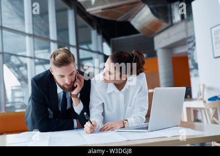 Two architects, business people working on plan at modern office Stock Photo