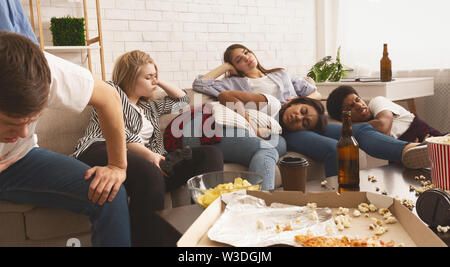 After party. Teen friends suffering from headache and stomachache Stock Photo