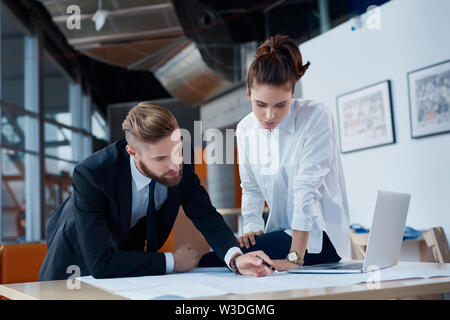Busy architects at office working on construction plan Stock Photo
