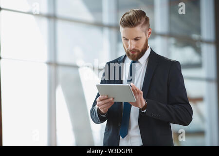 Modern hipster businessman with digital tablet at office Stock Photo