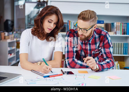 Small web designers team working on new project developing new website layout Stock Photo