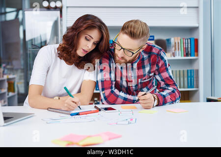 Two web designers prototyping responsive design for mobile apps Stock Photo