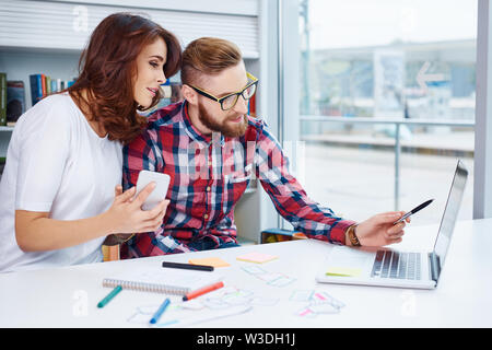 Web designers working on laptop at office Stock Photo