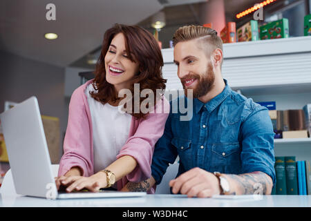 Happy designers working on laptop at office Stock Photo