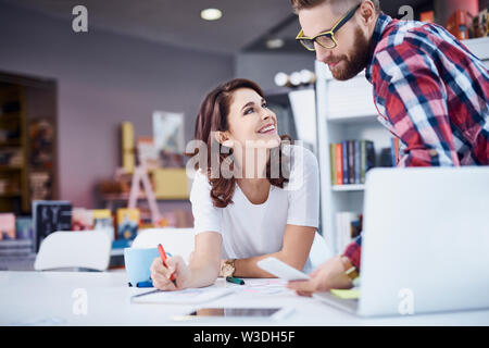 Two hipsters, designers discussing at office, working together Stock Photo