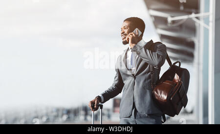 Always in Touch. Entrepreneur Talking on Phone at Airport Stock Photo