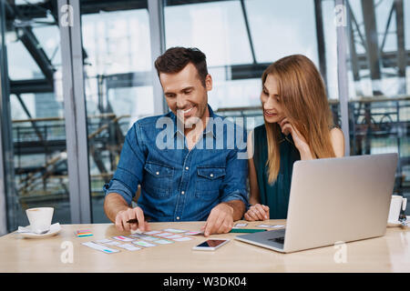 Happy web designers creating responsive design mockup Stock Photo