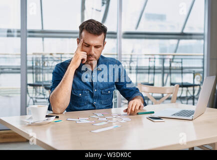 Thoughtful web designer working on website project at office Stock Photo