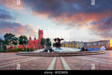 Red Church or Church Of Saints Simon and Helen, Fountain at independence Square in Minsk, Belarus Stock Photo