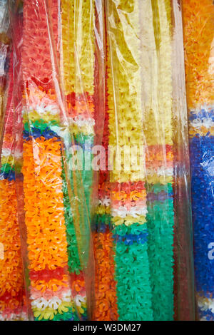 Indian Puja flower strands, for sale at the busy local market, Talat Warorot, in Chiang Mai, Thailand. Stock Photo