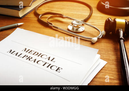 Medical malpractice report and stethoscope. Stock Photo