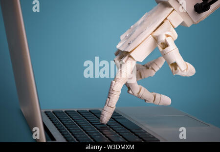 Robot finger point to laptop button, free space Stock Photo