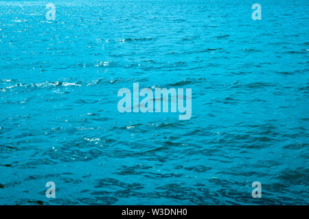 Blue azure water in the sea. Waves on the surface of the water. Abstract background. Stock Photo