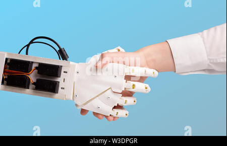 Robot and human holding hands with handshake Stock Photo