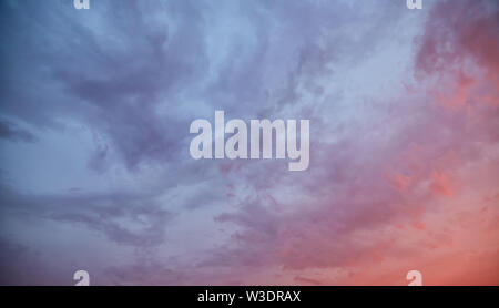Dramatic sky at sunset with clouds lit by the setting sun Stock Photo