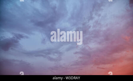 Dramatic sky at sunset with clouds lit by the setting sun Stock Photo