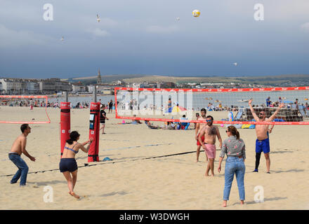 People playing beach volleyball in Summer on Weymouth Beach in the UK Stock Photo