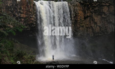 Waterfalls of Australia. A lone tourist standing before the Trentham  waterfalls in Victoria. Stock Photo