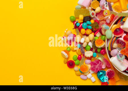 colored candies on yellow background Stock Photo