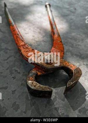 Metal hammer, pliers, gloves on Metal background Stock Photo
