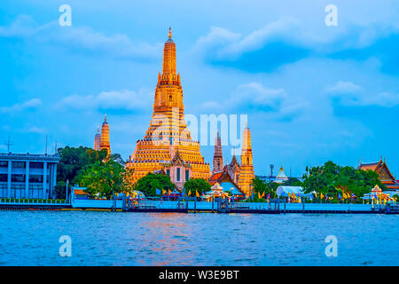 The magnificent Wat Arun temple in evening illumination is one of the most notable landmark of Bangkok, Thailand Stock Photo