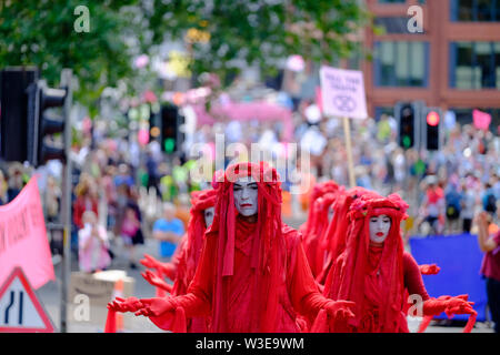 Bristol, UK, 15th July 2019.  The Red Brigade. As part of the Extinction rebellion movement summer uprising a group have occupied Bristol Bridge in the center of the city. The protest is to raise awareness of the speed of climate change and the lack of action to stop it. The protestors have worked with local agencies to ensure a safe and peaceful protest, police are present and diversions in place. Further occupations are planned throughout the city this week. Pictured are the red brigade group Stock Photo
