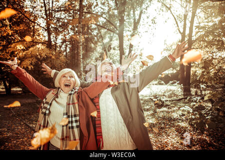 Cheerful married couple being excited at autumn. Stock Photo