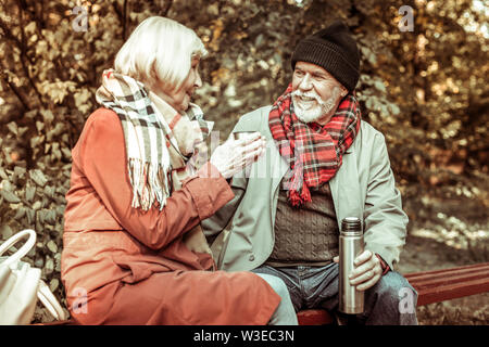 Senior couple drinking tea in the park. Stock Photo