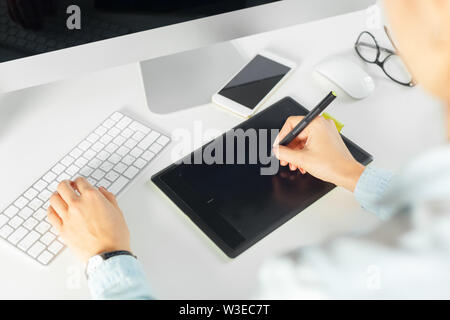 Young female designer using graphics tablet Stock Photo